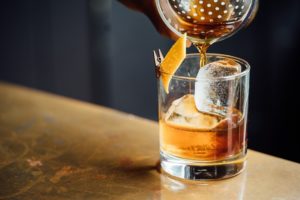 a whiskey cocktail is poured